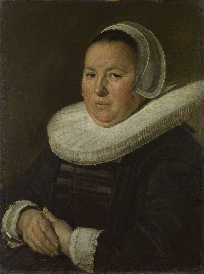 Portrait of an elderly woman with clasped hands