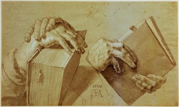 Two pairs of hands holding a book