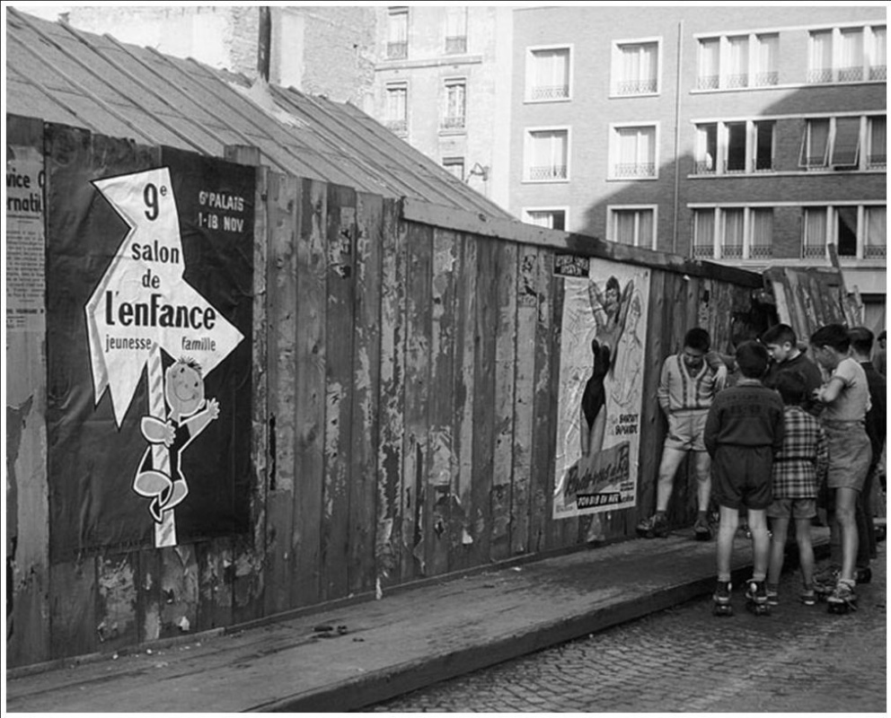 Historical photos. Boys look at a poster with a half-naked woman